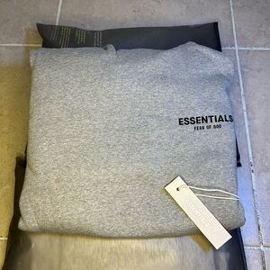Dark oatmeal essentials hoodies 
Brand new/with tags 
Size XS